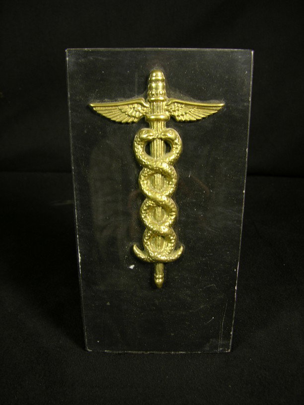 I Dream of Jeannie Desk Prop: Black marble desk ornament with caduceus symbol attached, used on the office of Dr. Bellows (Hayden Rouke) in the television series I Dream of Jeannie. Dr. Bellows was the show's resident psychiatrist
