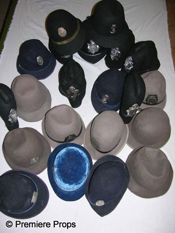 Lot of British Police/Security Hats: Lot of 23 British Bobby-type Police hats, 17 of which have badges with varying titles such as Special Police, Security Guard, Private Detective, etc. One marked "West Yorkshire Metropolitan Police" is