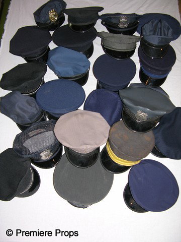 Lot of Service Industry Hats: Mixed Lot of Police, Chauffeur, Doorman and Security variety, with and without badges, in black and dark blue.