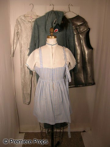 Lot of "The Wizard of Oz" Costumes: Large lot from the classic musical "The Wizard of Oz" including 3 Dorothy costumes, Tin Man parts, including silver vests and jumpsuits & a full Monkey costume.
