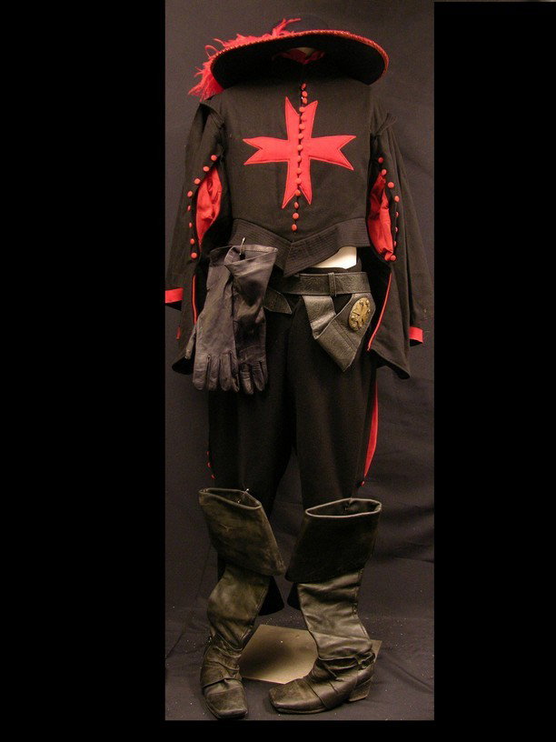 Three Musketeers Cardinal Guard Costume: Three Musketeers (2011) - Cardinal Guard's screen worn, ornately designed costume. The costume jacket has a red cross on the front and back, red under the arms. The costume also includes a black with 