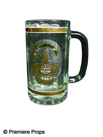 Beverly Hills Cop 2 Screen Used Cup: Glass cup with handle, featuring Beverly Hills Police badge motif on its side, used in the production of Beverly Hills Cop 2 (1987). This was Eddie Murphy's second outing as Axel Foley, a Detroit poli