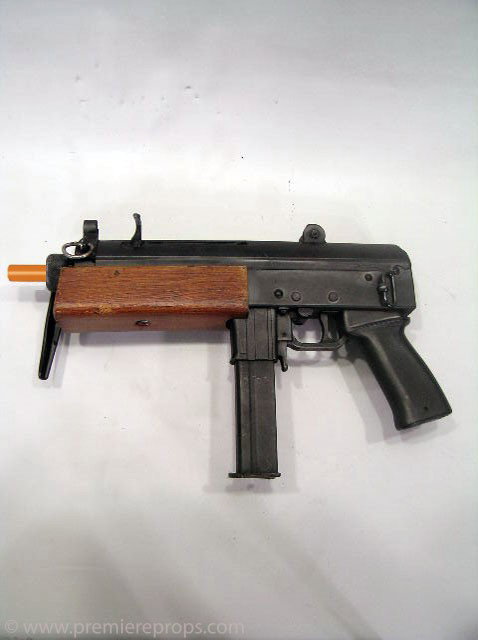 Underworld: Evolution AR-15 Machine Gun Prop: Underworld: Evolution (2006) - Black AR-15 Machine Gun screen used prop (measures 14" x 8.5" x 2"). Made from solid rubber with wood and metal accents. Paint flaking on metal stock piece. This is a pr