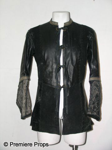 Camelot King Arthur (Jamie Campbell) Hero Jacket: This screen worn Hero black leather jacket was worn by Jamie Campbell Bower as King Arthur in HBO's Camelot. This fantastic jacket features leather twist tie 'buttons' in front, with the sleeves taper