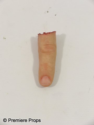 RED Screen used Severed finger & Blood.: From 2010's RED, directed by Robert Schwentke, this is a screen used prop severed finger from Bruce Willis' character Frank Moses. The finger is made from rubber and is approx. 3" long. There are remn