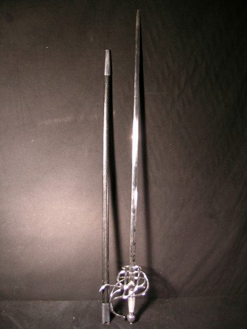 Pirates of the Caribbean Sword: From 2003's 'Pirates of the Caribbean - Curse of the Black Pearl,' this is an exquisitely made prop sword from the background scene at the Castle. The sword blade is made from thin steel with a pointe