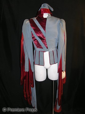 Roland Rego Screen Worn Jester Costume: Sky blue with red satin accents court jester costume for a period production, worn by Roland Rego in a 1930s film production. Includes a matching hat. Rego was a bit part player who appeared in films 
