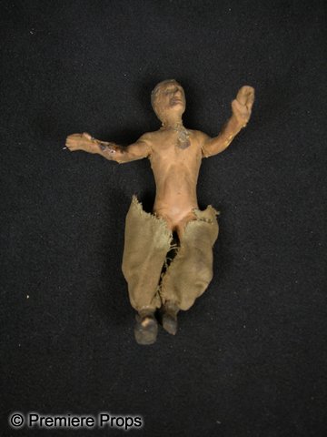 Screen Used Puppet from The Rains Came: Small puppet made of rubber and dressed in Indian style garb, used in The Rains Came (1939). The film featured an elaborate flood sequence, one in which miniatures such as these were utilized. The fil