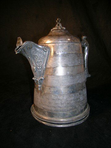Addams Family Teapot: This is a background prop teapot from used during the production of the 'Addams Family' movies from 1991 and 1993. This gothic looking prop is made from a silver metal, and is ornately designed. Tip o