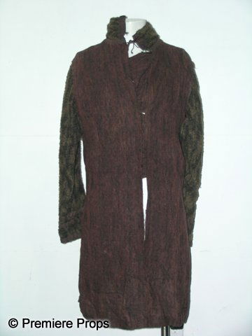 Camelot Merlin (Joseph Fiennes) Hero Tabard: Brown knitted tabard worn by actor Joseph Fiennes as Merlin from the HBO Series 'Camelot.' (2011) This screen used hero costume features gold and black arm sleeves fastened into a mauve tunic. The tun