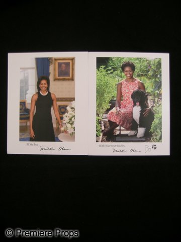 Lot of Signed Michelle Obama Photos: This is a lot of (2)autographed glossy color photos, signed by Michelle Obama. One of the photos features Michelle Obama in a black dress, and the other has her in a red & white summer dress with fami