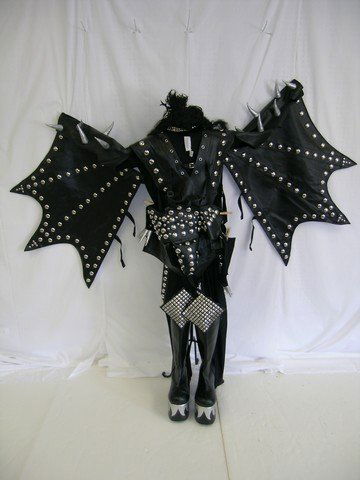 Gene Simmons "Kiss" costume: 1 Gene Simmons "Kiss" costume complete with tights, vest with attached wings, cod piece, wig, gloves, collar and boots.