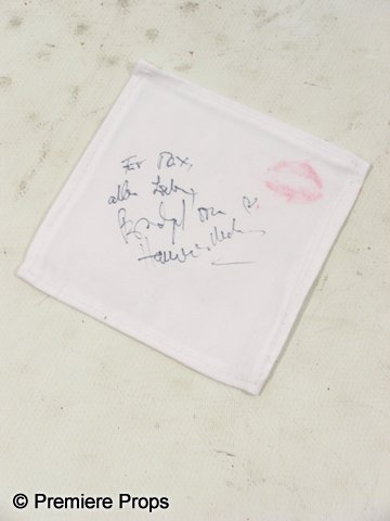 Inglourious Basterds signed 'Bridget' napkin: A White cloth napkin signed by Diane Kruger's character Bridget von Hammersmark from 2009's Inglourious Basterds, directed by Quentin Taratino. The napkin is approx. 6 1/2" x 6 1/2" and is signed in G