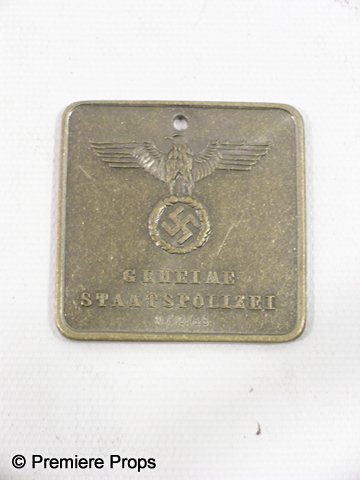 Inglorious Basterds Nazi Logo Medal: From Quentin Tarantino's 2009 war epic 'Inglorious Basterds,' this is a prop Nazi medal. The square shaped medal is made from a silver steel or pewter material, with an Eagle sitting atop a swastika, 