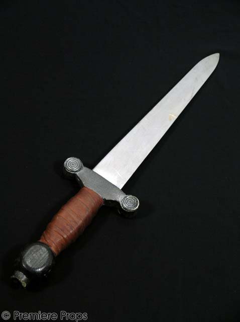 DUNGEONS AND DRAGONS Silver Dagger MOVIE PROPS: From the 2005 fantasy epic, this is a screen used prop dagger. The intricately detailed faux-dagger features a broad 10” long blade with a blunt point, a 6” long hilt wrapped in brown leather, a s