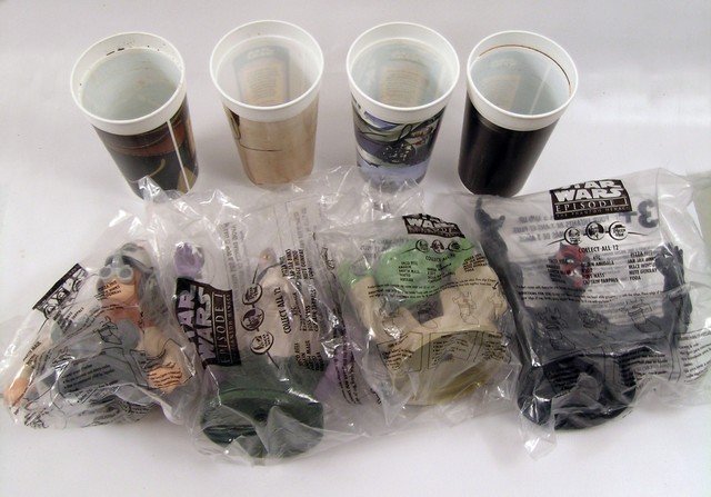 Star Wars George Lucas Signed Promo Cups: From the Taco Bell "Star Wars" collection, these special collector's cups are all signed by George Lucas. They represent Yoda, Yoda, Darth Mall, a Gungun and Anakin in his pod racer attire. Obtained f