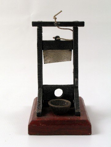 The Addams Family (1964) Small Guillotine Prop: A background set prop from the classic "The Addams Family" (1964), this is a small wood and metal guillotine! (Approx. 5 1/2" x 4").