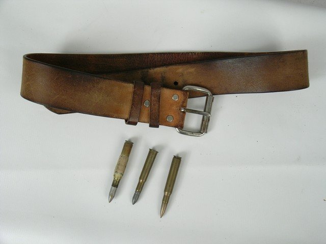 The Professionals Gun Belt & Bullets Props: From the 1966 western classic "The Professionals", this is a leather belt with roller belt buckle, plus ammo bullet casings (one approx 3", two approx 3.5"), used in the movie. They were given to one 