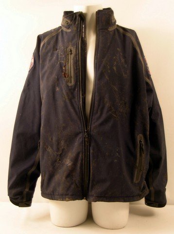 12 Rounds Reloaded Nick Malloy (Randy Orton) Movie: 12 Rounds Reloaded - Nick Malloy (Randy Orton) screen worn, hero, extremely distressed and bloody, navy blue with multiple zipper pockets, zipper up the front with Emergency Paramedic patches on the s
