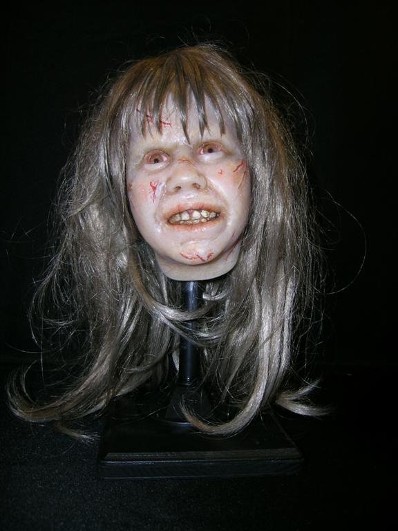 Bust of Linda Blair in The Exorcist: Bust of Linda Blair as Regan, the possessed girl of The Exorcist, measuring 15x9x8. Features faux hair and an array of demonic scars and bruises.