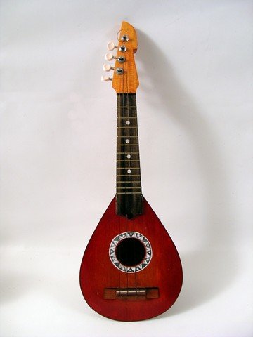 Hawaii 5-0 (1974) Ukulele Prop: For 12 seasons "Hawaii 5-0" ruled the airways and made everyone in the world want to come to 50th State. This is a wood ukulele used as a background prop in this classic TV series. (Approx. 21" long).