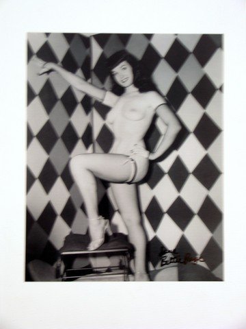Bettie Page Autographed Photo: Bettie Page, known as the "Queen of Pinups", became an American Icon in the 1950's. With her girl-next-door innocent look, jet black hair and blue eyes, plus her trademark bangs, she was instantly bel