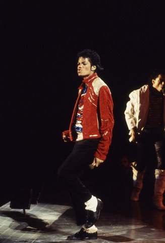Michael Jackson Concert Photo & Copyright From Victory: Michael Jackson in his other iconic fire and brimstone red outfit while performing on stage at his Victory Tour circa 1984. These photos were commission by Joe Jackson, father, founder and early manag