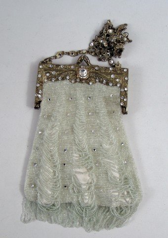 Casino Royale (2006) Jeweled Purse Prop: Casino Royale (2006) Jeweled Purse Prop - James Bond's "Casino Royale" (2006) brought the world one of the most successful Bond's in Daniel Craig. This is a small luxurious off-white with sparkle desi
