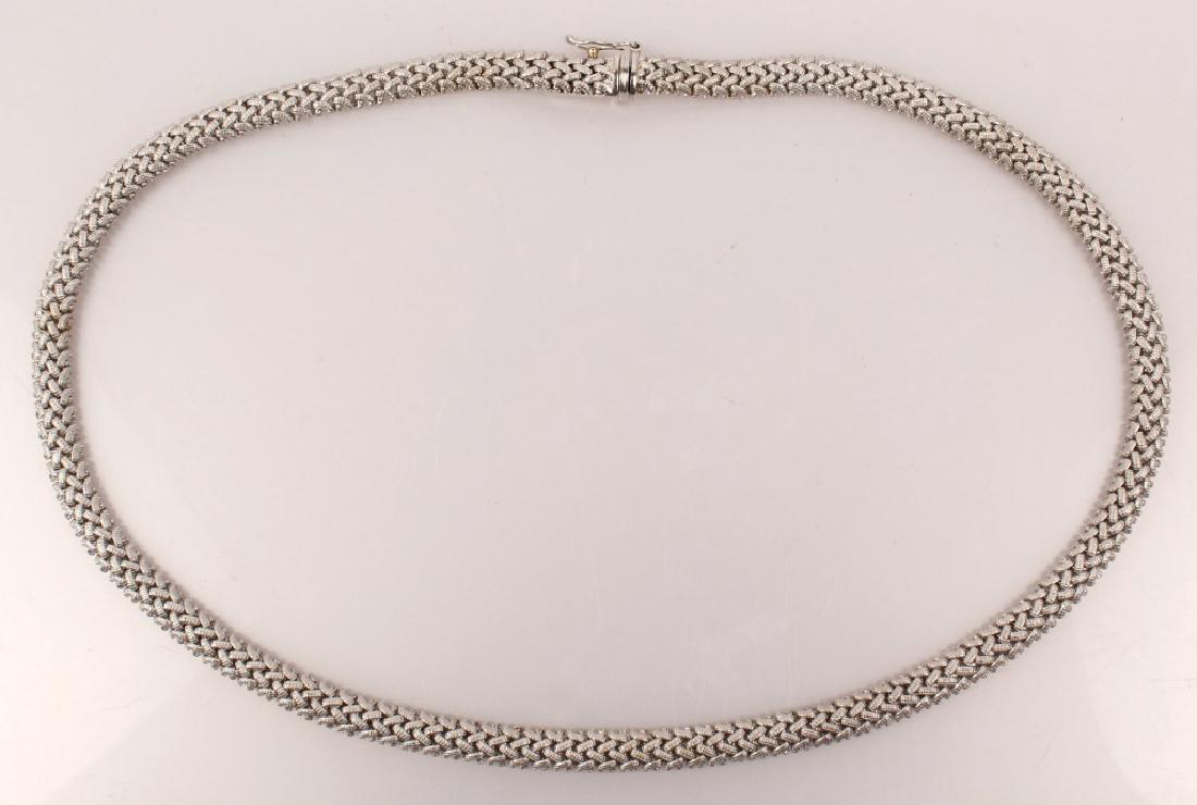 LADIES 14K WHITE GOLD BRAIDED OMEGA NECKLACE: LADIES 14K WHITE GOLD BRAIDED OMEGA NECKLACE Expertly crafted, matte finish braided texture 6mm wide necklace. 17" length overall with integrated box clasp and safety latch. Weight: 36.3 Grams Size: 1