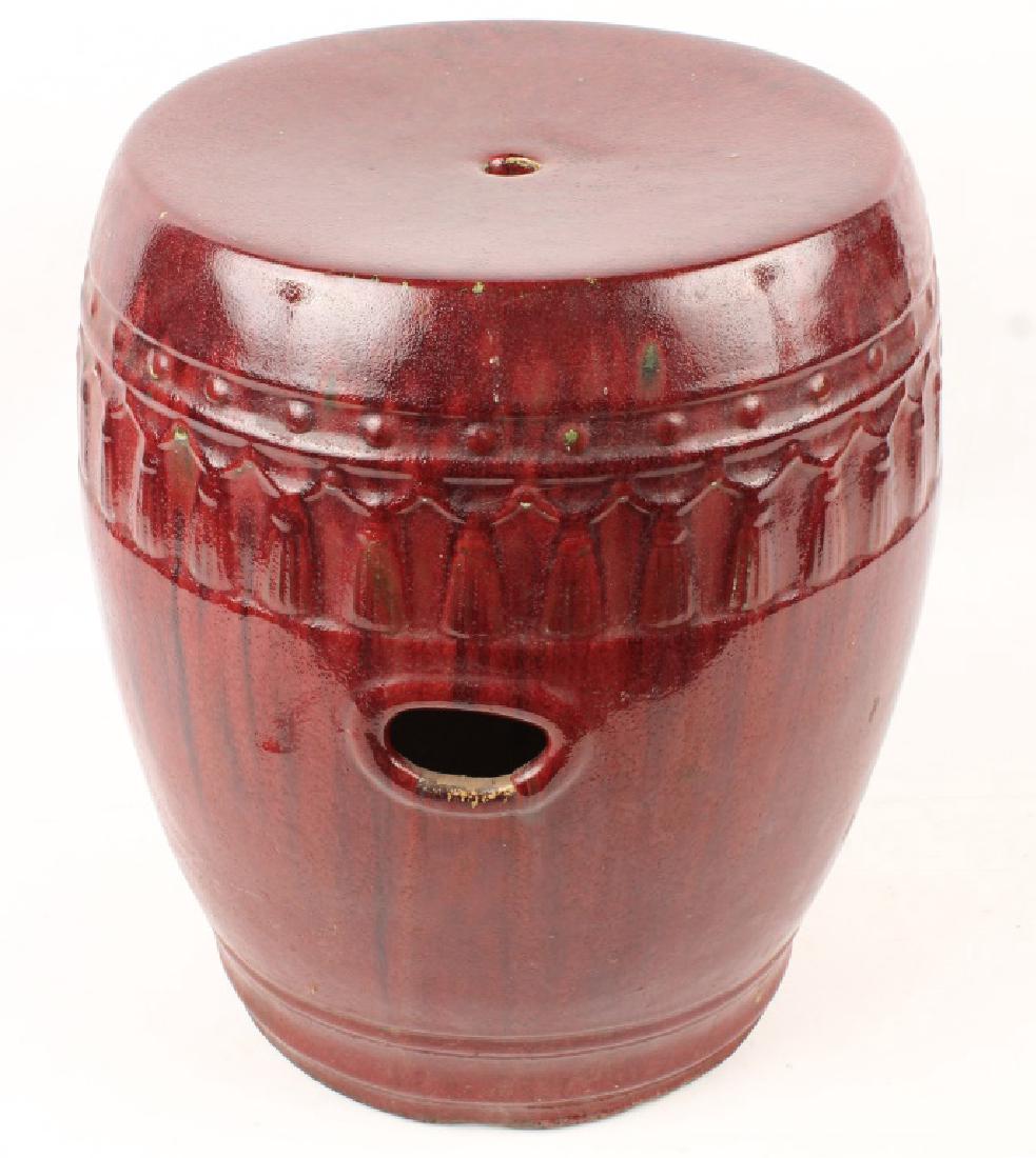 MAROON CERAMIC GARDEN SEAT: MAROON CERAMIC GARDEN SEAT Glazed maroon, tassel and beaded pattern. Size: 16.5"