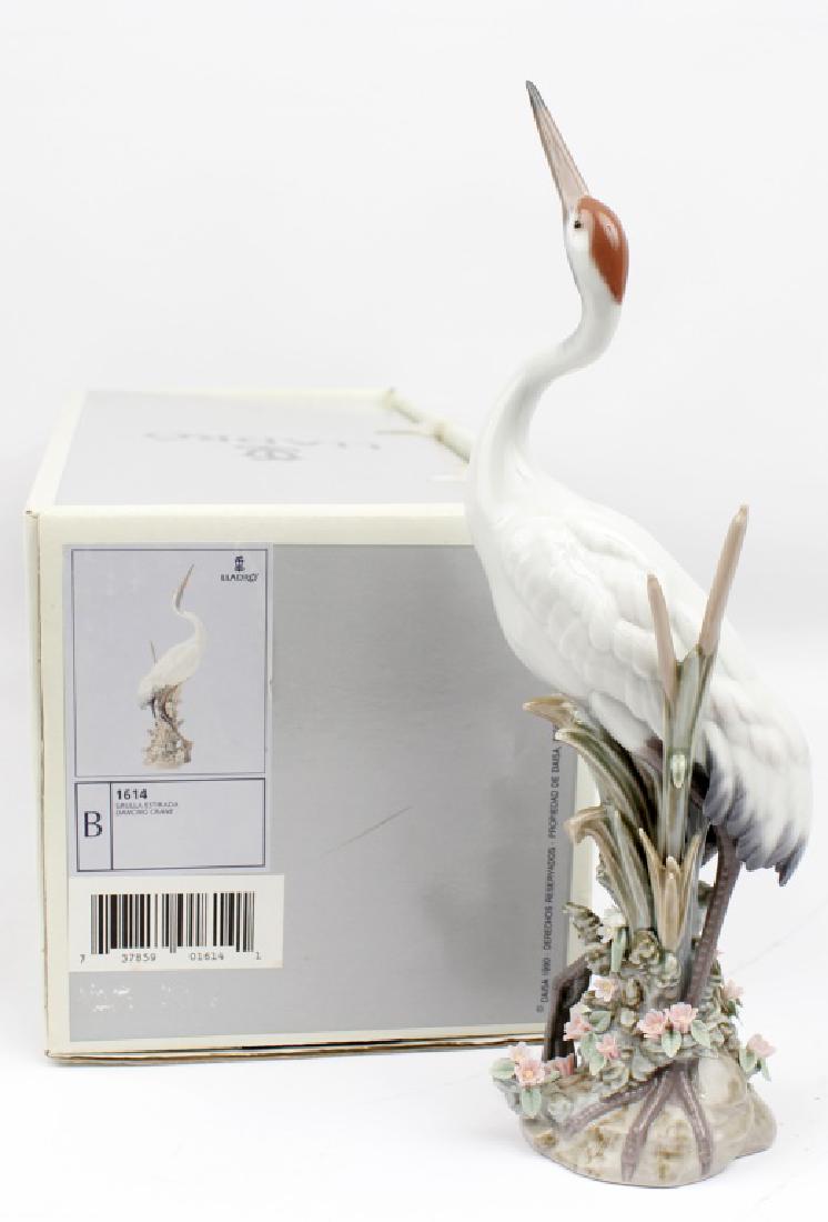 LLADRO FIGURINE DANCING CRANE #1614: LLADRO FIGURINE DANCING CRANE #1614 Lladro Figurine "Dancing Crane" #1614. Hand crafted delicate Crane, perched in a landscape of pink flowers and cattails. Mint in Original Box, By Sculptor Salvador