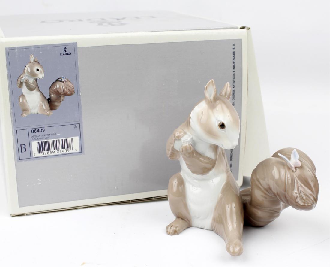 LLADRO PORCELAIN FIGURINE A SURPRISE VISIT #6409: LLADRO PORCELAIN FIGURINE A SURPRISE VISIT #6409 Lladro porcelain figurine "A Surprise Visit" number 6409. A Squirrel holding an accorn with a butterfly on its tail. Hand crafted in Spain and in origi
