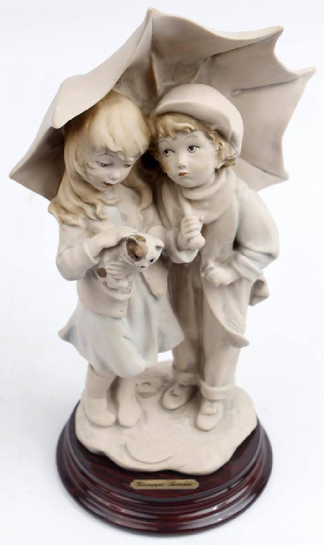 GIUSEPPE ARMANI FIGURINE UNDER THE UMBRELLA: GIUSEPPE ARMANI FIGURINE UNDER THE UMBRELLA Giuseppe Armani figurine of a boy and girl under an umbrella titled "Under the Umbrella". number 06892, made in Italy and no original box. Size: 10"