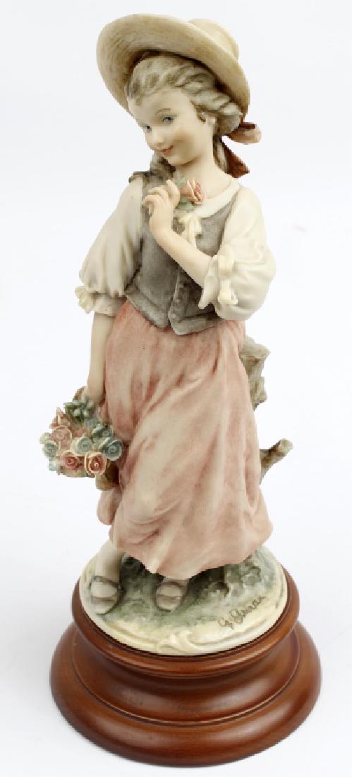 GIUSEPPE ARMANI FIGURINE GIRL WITH FLOWERS: GIUSEPPE ARMANI FIGURINE GIRL WITH FLOWERS Giuseppe Armani Italian figurine of a girl with a basket of flowers in a pink dress. Made in Italy, no original box. Size: 11"