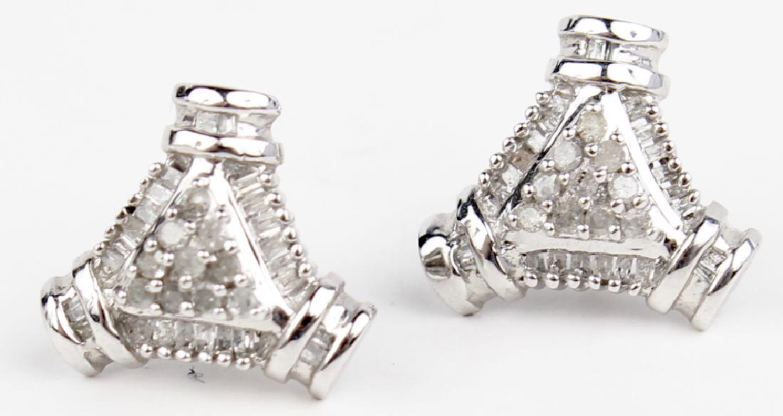 10K WHITE GOLD LADIES DIAMOND STUD EARRINGS: 10K WHITE GOLD LADIES DIAMOND STUD EARRINGS 10k white gold ladies diamond stud earrings. 0.51cttw in diamond clusters of round and baguette cut diamonds. Weight: 3.1 g Size: 15mm x 13mm