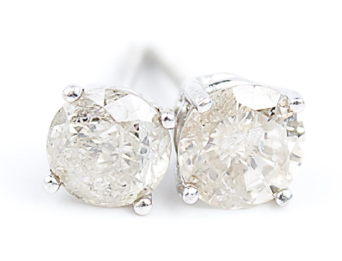 14K WHITE GOLD DIAMOND STUD EARRINGS: 14K WHITE GOLD DIAMOND STUD EARRINGS 14k white gold diamond solitaire stud earrings. 0.61ct round champagne colored diamonds in a four prong white gold setting. 1.22cttw. Weight: 1 g
