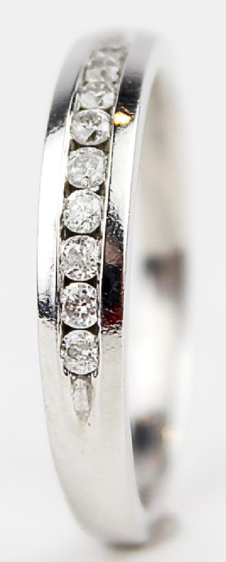LADIES 14K WHITE GOLD DIAMOND WEDDING BAND: LADIES 14K WHITE GOLD DIAMOND WEDDING BAND ladies 14k white gold and diamond wedding band ring. A bezel setting holds (9) beautiful round .01ct accent diamonds in a simplistic design that would compli