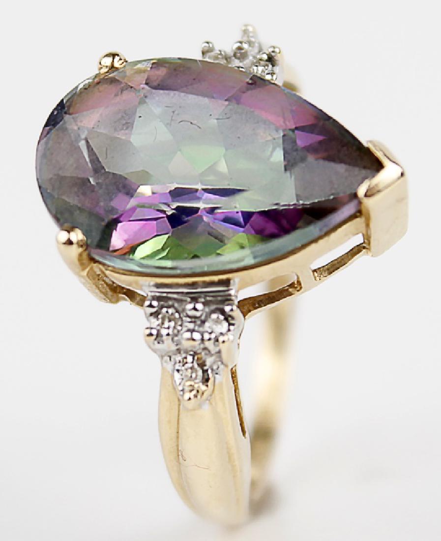 14K YELLOW GOLD MYSTIC TOPAZ LADIES FASHION RING: 14K YELLOW GOLD MYSTIC TOPAZ LADIES FASHION RING 14k yellow gold ladies fashion ring. A Pear shaped center mystic topaz measures 11mm x 14mm, accented with (6) .01ct round diamonds. Weight: 4.6 g Size