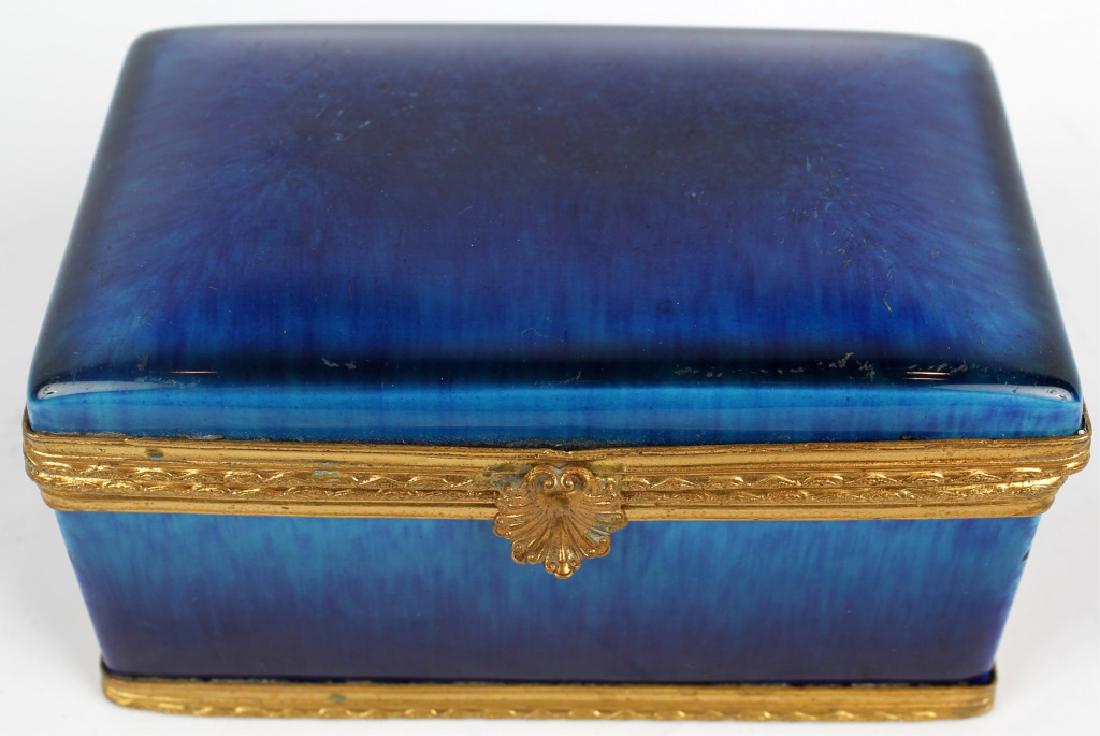 FRENCH PAUL MILET SEVRES PORCELAIN DRESSER BOX: FRENCH PAUL MILET SEVRES PORCELAIN DRESSER BOX Porcelain French royal blue dresser box, by Paul Milet Sevres. Stamped on bottom "MP Sevres". Gold clasp and detail trim. Size: 6" x 4" x 3.5"