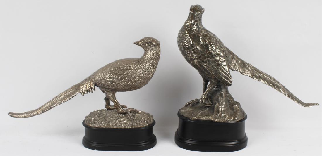 ORNAMENTAL SILVER PLATED PHEASANT STATUES LOT OF 2: ORNAMENTAL SILVER PLATED PHEASANT STATUES LOT OF 2 Ornamental decorative silver plated pheasant statues. Lot of two. Both on black wooden round bases. (1) 16" x 15" and (1) 16" x 12". Size: (1) 16" x 