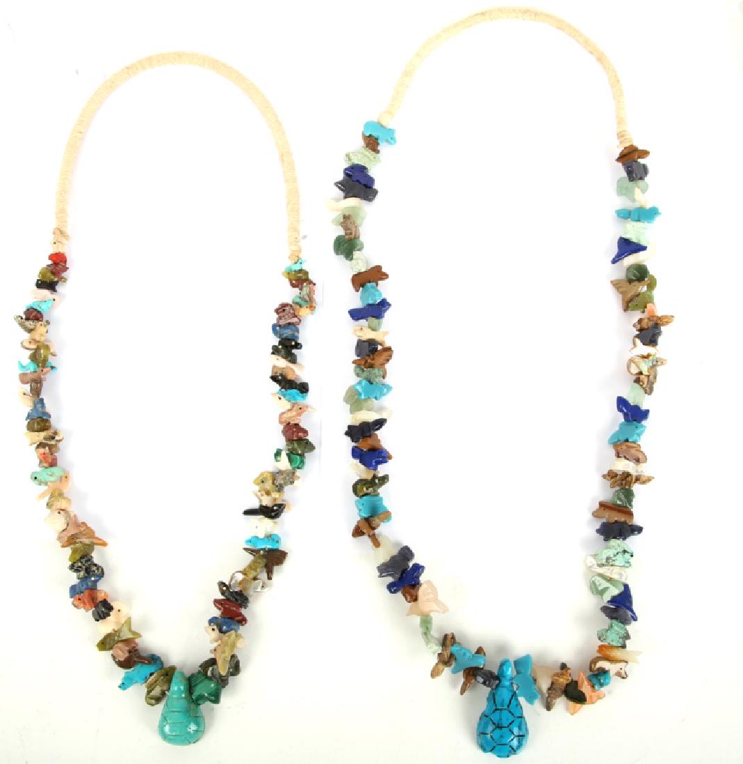 PAIR OF TURQUOISE ZUNI FETISH NECKLACES: PAIR OF TURQUOISE ZUNI FETISH NECKLACES Pair of Zuni fetish necklaces, featuring turquoise, malachite, onyx, mother of pearl, and other stone carved fish and birds. Weight: 246.7g Size: 28" and 32"