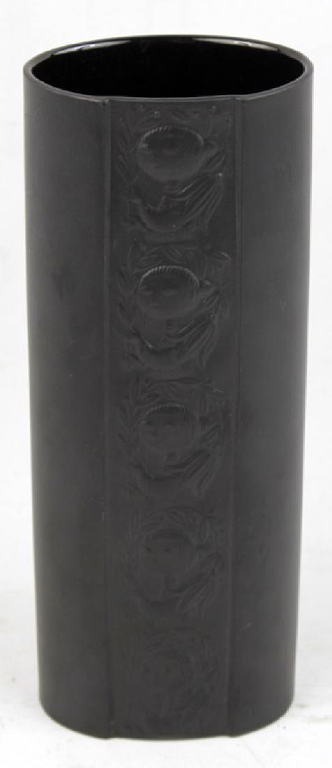 ROSENTHAL BJORN WIINBLAD ETCHED BLACK VASE: ROSENTHAL BJORN WIINBLAD ETCHED BLACK VASE Rosenthal Bjorn Wiinblad etched black vase. Repeated patterning of a face etched into the porcelain with a matte black glaze. Signed on base. Size: 8.5"
