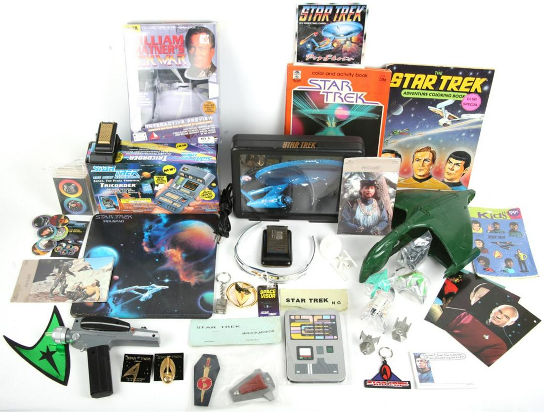 25 STAR TREK ITEMS - TOYS, FIGURES, PINS, ETC.: 25 STAR TREK ITEMS - TOYS, FIGURES, PINS, ETC. Lot of twenty five Star Trek collectibles, to include: 4 pins, 3 keychains, 2 pewter model ships, 4 plastic vehicles on stands, 1979 Dinky Enterprise, 19