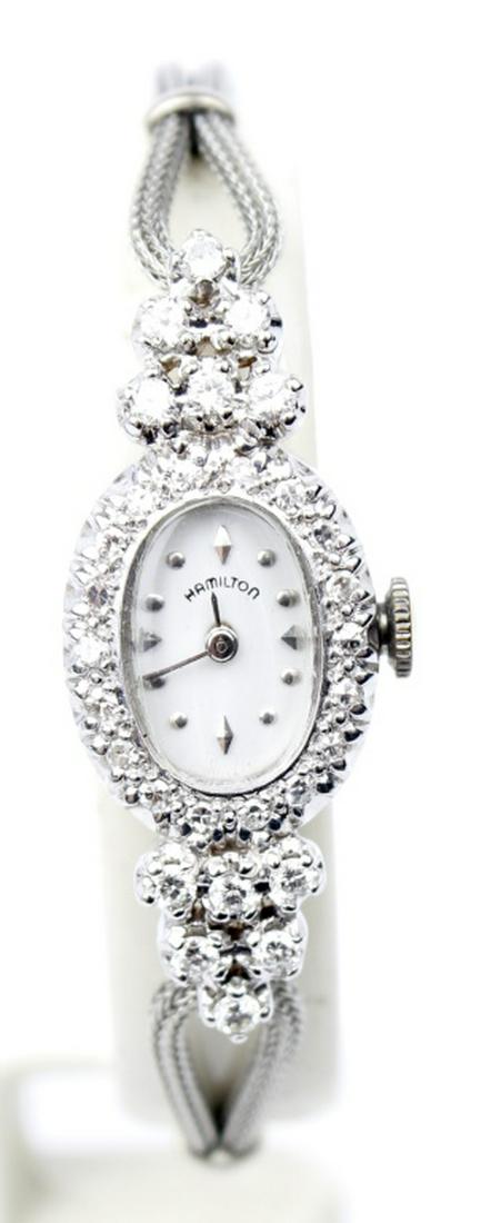 ANTIQUE 14K WHITE GOLD DIAMOND HAMILTON WATCH: ANTIQUE 14K WHITE GOLD DIAMOND HAMILTON WATCH One ladies diamond Hamilton wristwatch. Set with 35 diamonds in 14k white gold. White dial, white batons, 17 jewel Hamilton movement Model 768, Swiss manu