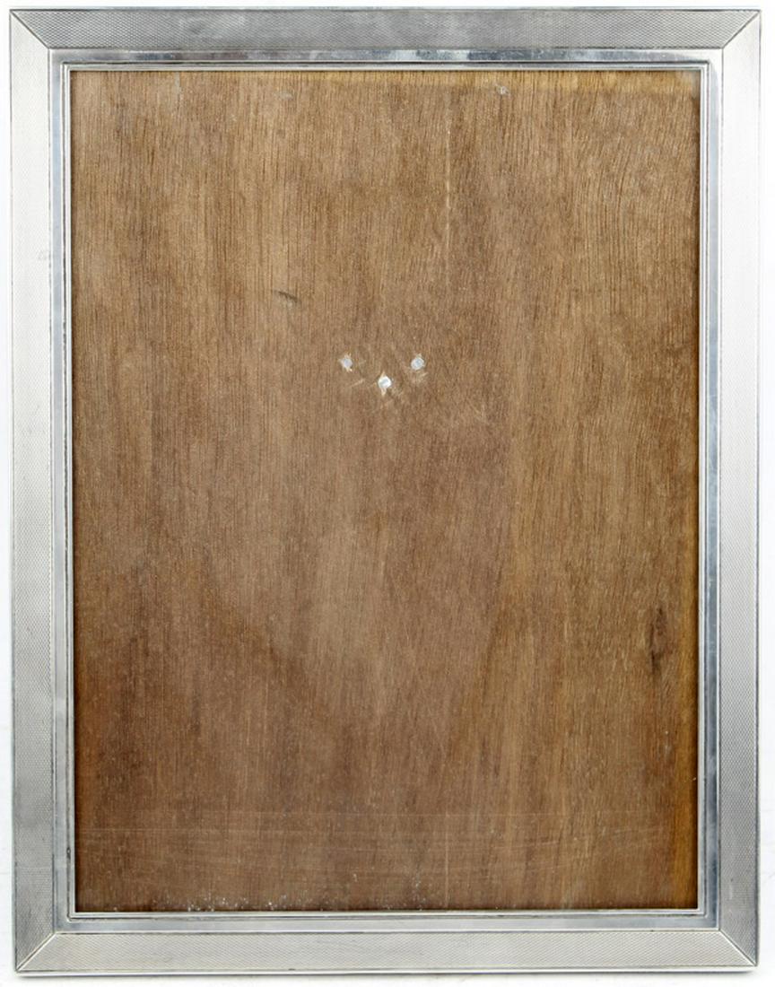 JOHANN FRANZ GERMAN STERLING SILVER FRAME: JOHANN FRANZ GERMAN STERLING SILVER FRAME An attractive vintage sterling silver, finely engine turned picture frame, 10 5/8 x 8 1/2 inches, suitable for 10 x 8 portraits. Wood slider easel back. Stamp