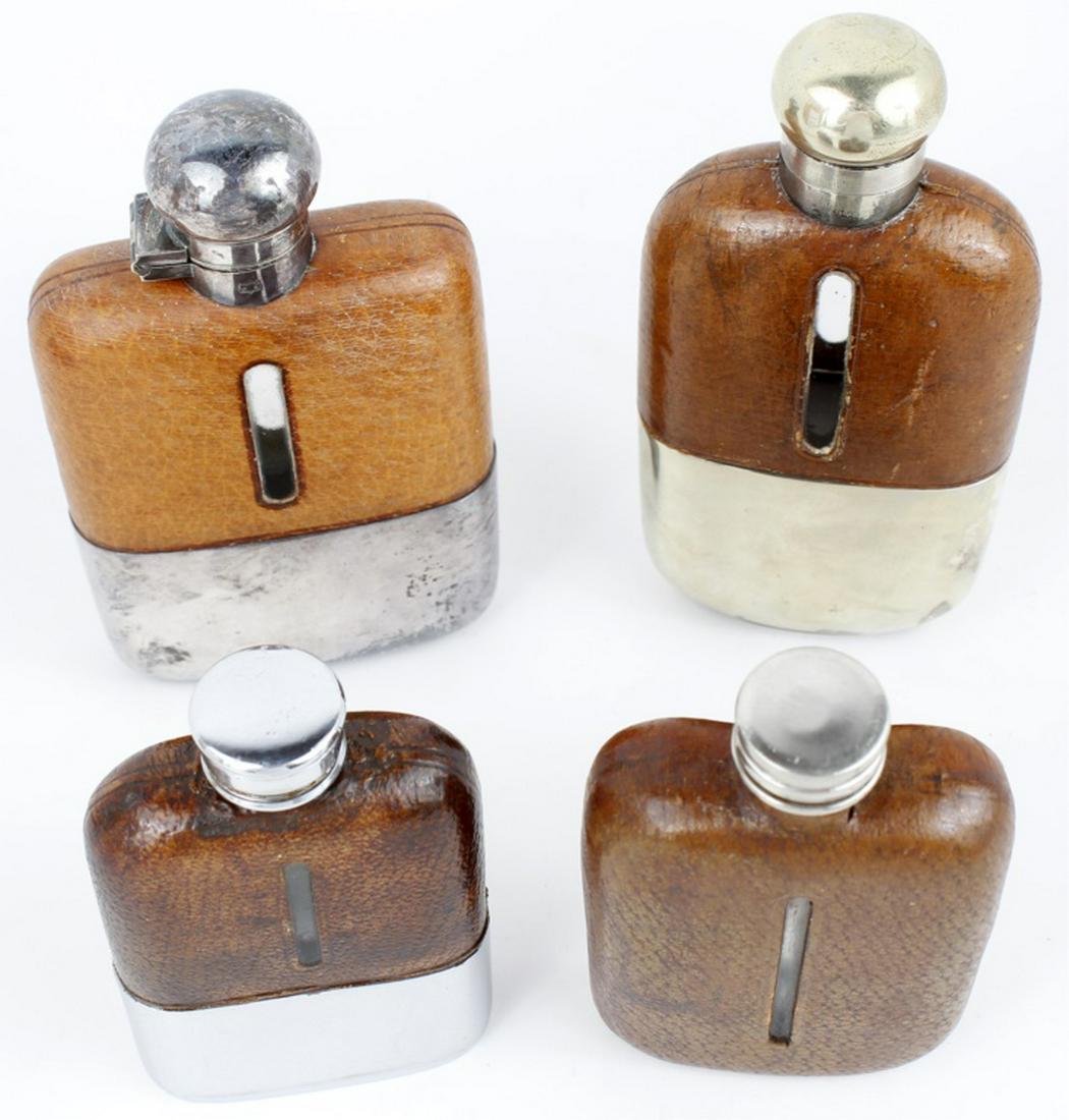 ENGLISH LEATHER & SILVER HIP FLASKS - LOT OF 4: ENGLISH LEATHER & SILVER HIP FLASKS - LOT OF 4 To include: A late 19th Century small leather, glass and silver plate (lid) hip flask, the leather cut away to indicate liquid levels. Very good conditio