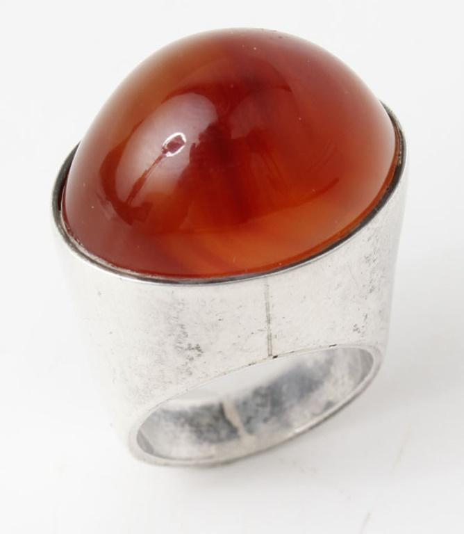 STERLING SILVER DAVID ANDERSEN MODERNIST RING: STERLING SILVER DAVID ANDERSEN MODERNIST RING Ladies sterling silver David Andersen Norwegian designer modern ring with bulb set orange red carnelian, signed inside band. Weight: 19.5 grams Size: appr