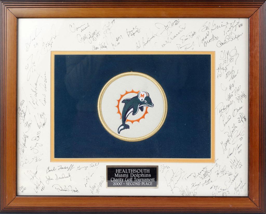 MIAMI DOPLPHINS CHARITY GOLF SECOND PLACE FRAMED: MIAMI DOPLPHINS CHARITY GOLF SECOND PLACE FRAMED Healthsouth 2000 Miami Dolphins Charity Golf Tournament second place framed patch with many players signatures. Size: 21" x 17"