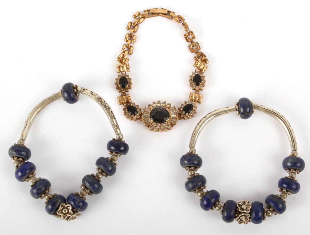 CHINESE BRACELETS W/ LAPIS & BLACK COLORED BEADS: CHINESE BRACELETS W/ LAPIS & BLACK COLORED BEADS Chinese metal bracelets - lot of 3. Two bracelets are silver with lapis colored beads and the other is an onyx rhinestone bracelet. Condition: Very fin