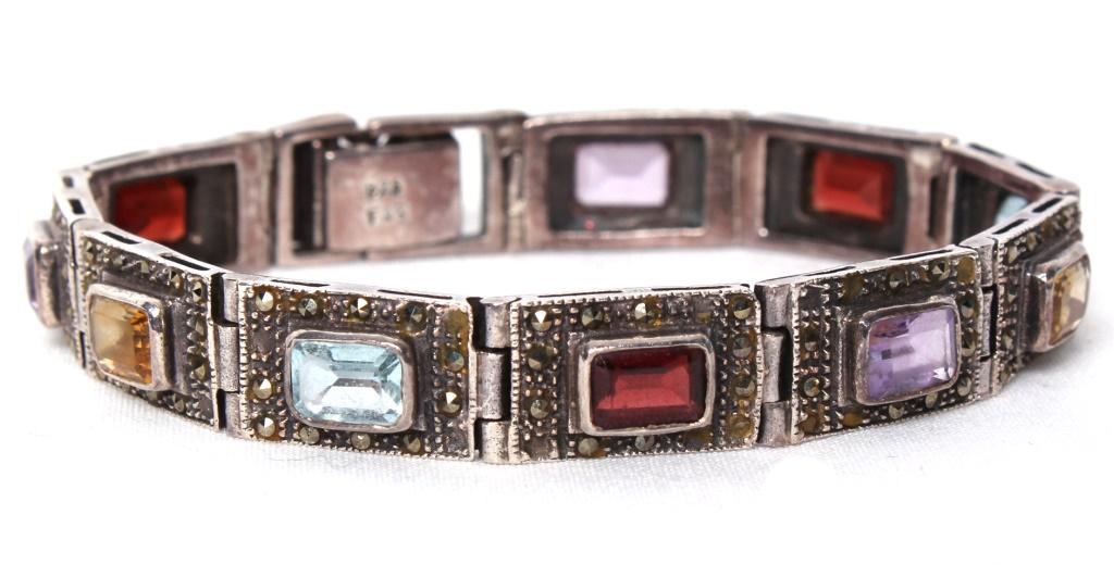 STERLING SILVER VINTAGE FILIGREE GEMSTONE BRACELET: STERLING SILVER VINTAGE FILIGREE GEMSTONE BRACELET Sterling silver vintage filigree mixed gemstone ladies bracelet with citrine, aquamarine, amethyst, and garnet. Marcasite accents. Weight: 24.9 Grams